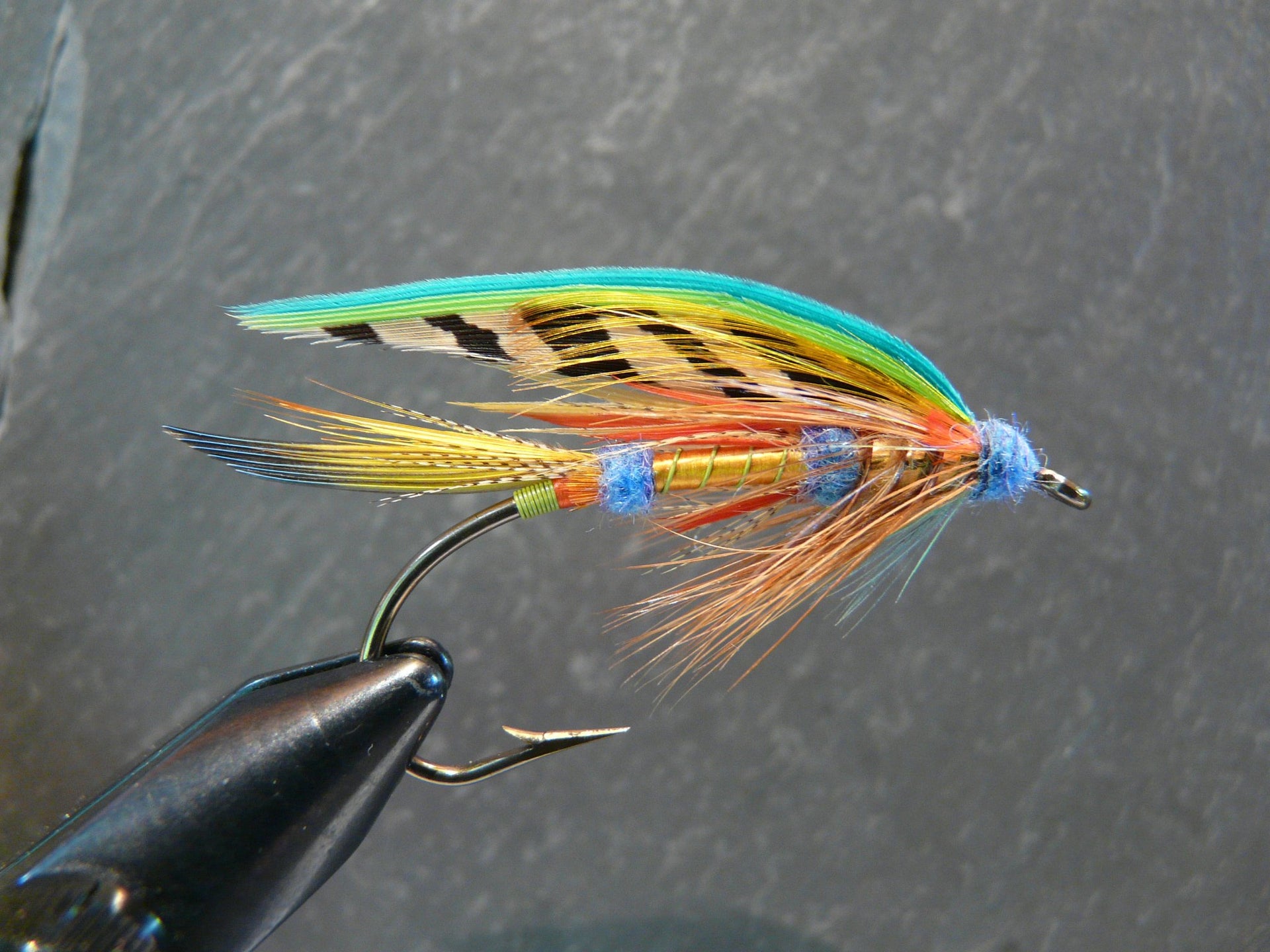 Tying feathers to the hooks of our lures 